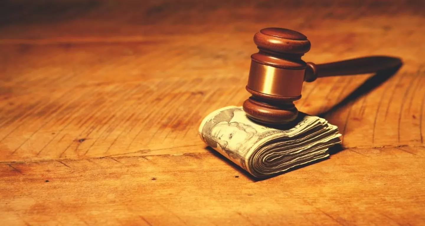 gavel on wad of dollars bills for New Jersey personal injury case